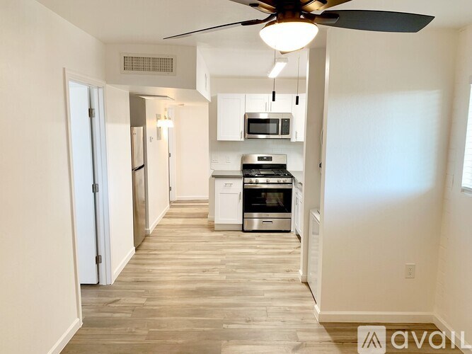 A kitchen with a fan and a microwave.