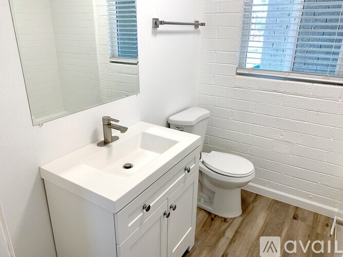 A white bathroom with a toilet and sink.