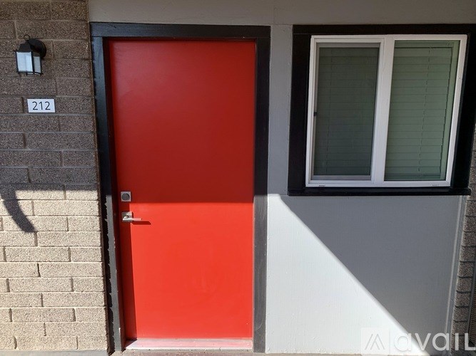 A red door is on the left side of a grey door.