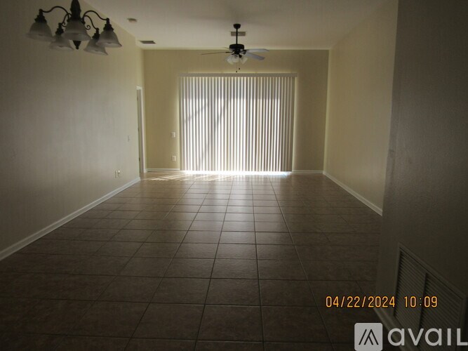 A room with tiled flooring and a ceiling fan.
