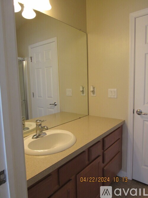 A bathroom with a sink and mirror.