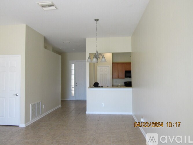 A room with a white door and a white counter in the middle of the room.