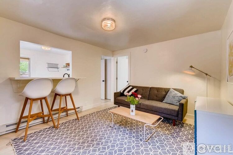 A living room with a grey and white tiled floor.