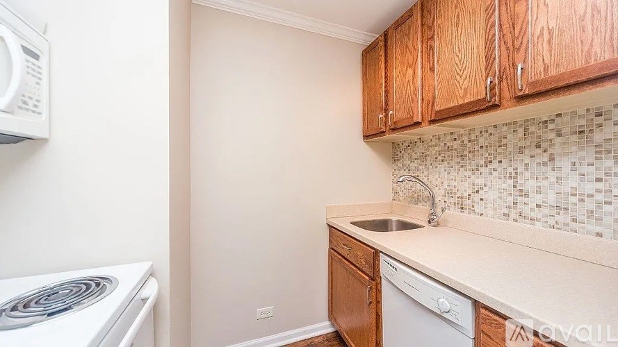 A kitchen with a white microwave and a white dishwasher.