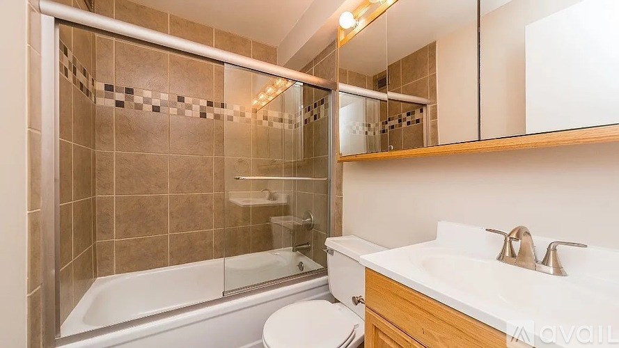 A bathroom with a white tub and sink.