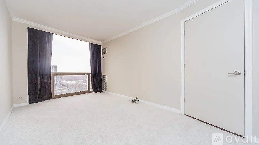 A room with a large window and a door.