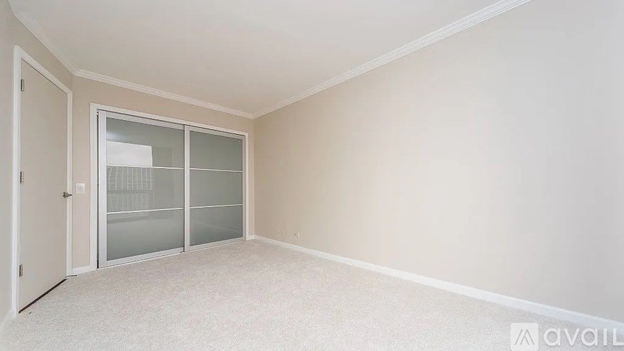 A room with a white door and a glass window.