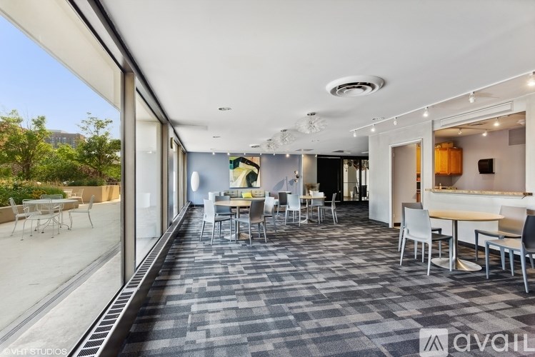 A modern dining area with a long table and chairs.
