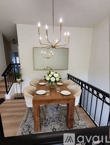 A dining room with a wooden table and white chairs.