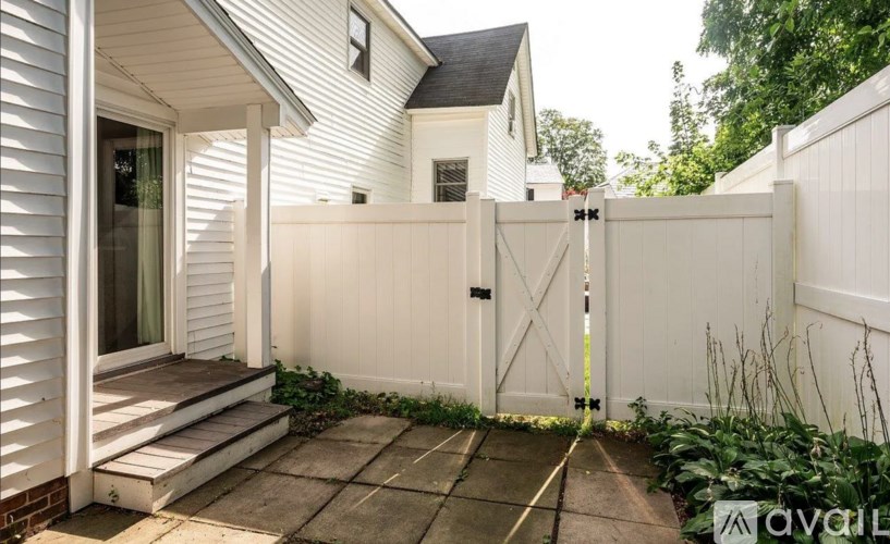 A white house with a white fence and gate.
