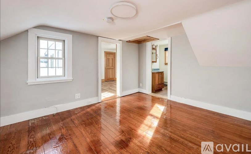 A room with wooden floors and a window.