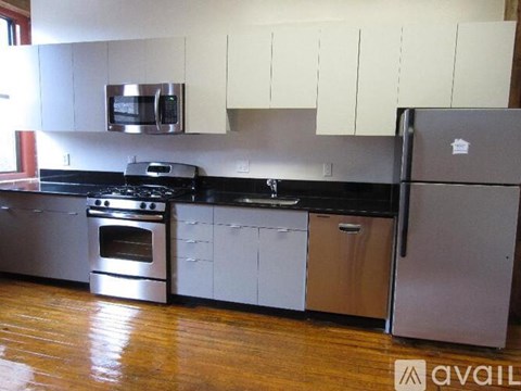 A kitchen with a stainless steel refrigerator and a stainless steel oven.