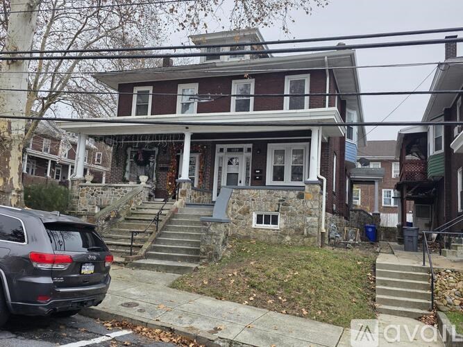 A house with a car parked in front.