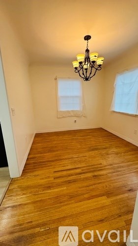 A room with wooden floors and a chandelier.