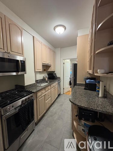 A kitchen with a stove top oven and microwave.