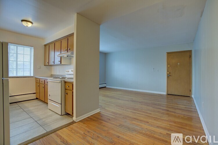 A kitchen with wooden floors and white appliances.