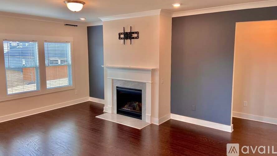 A living room with a fireplace and a chandelier.