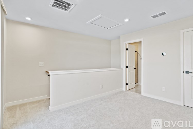 A white room with a door and a window.
