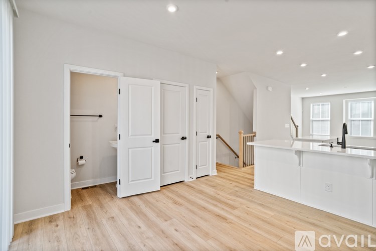 A white kitchen with wood floors and a white cabinet.