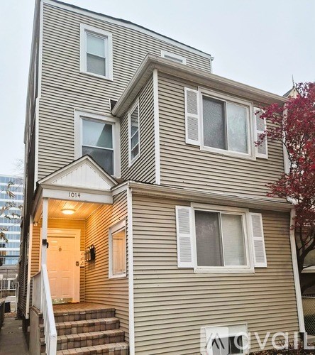 A two-story house with the number 1014 on the front door.