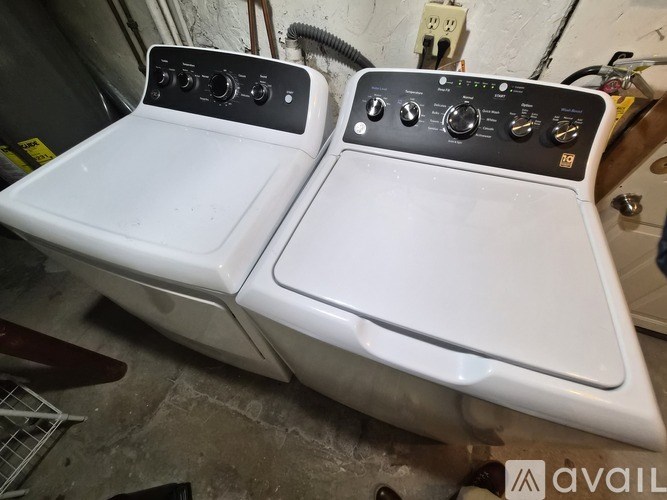 Two front load washing machines are sitting side by side.
