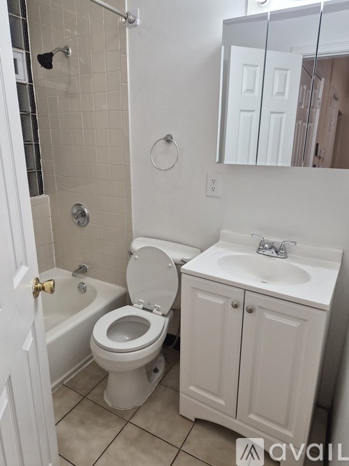 A white toilet and sink in a bathroom.