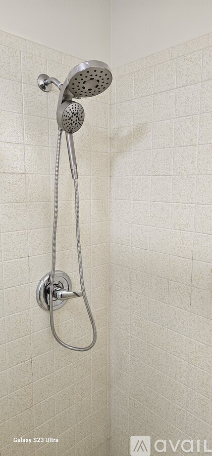 A shower head with a hose attached to it.