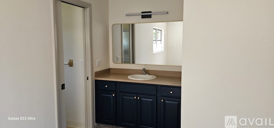 A bathroom with a sink and mirror.