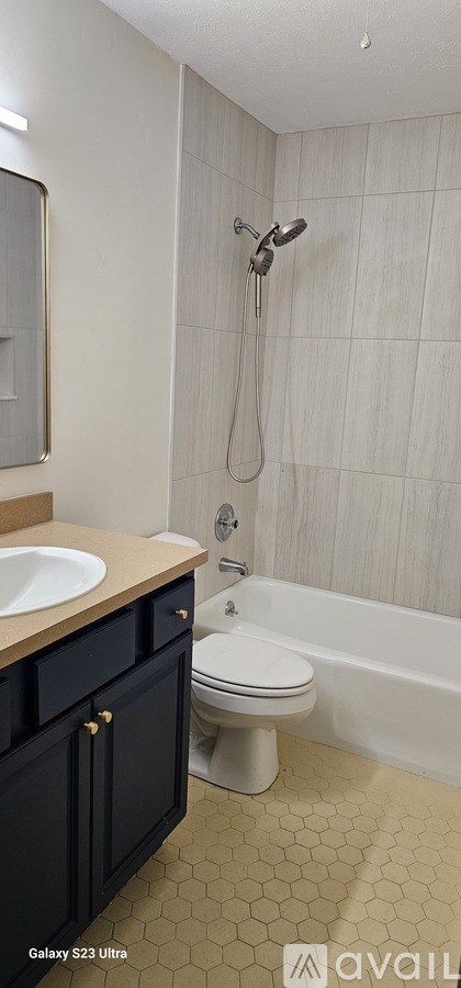 A bathroom with a white toilet and a shower with a glass door.