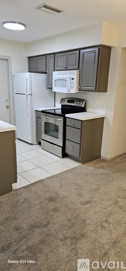 A kitchen with a white refrigerator and a white oven.