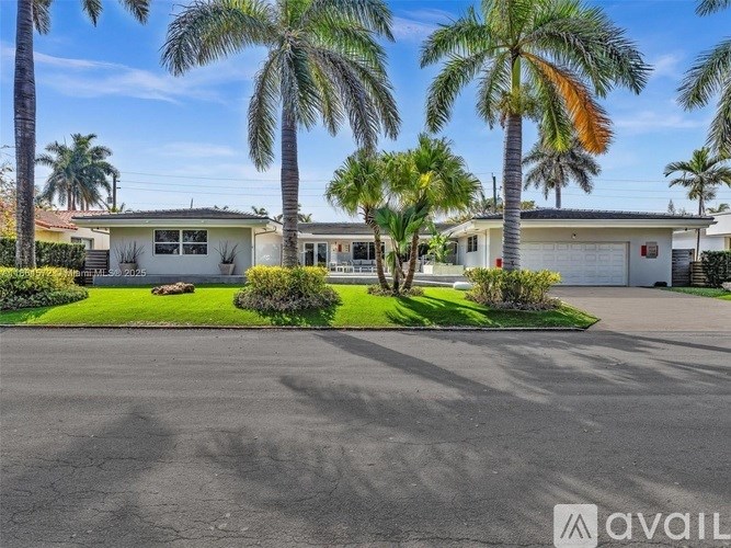 A row of houses with a driveway in front.