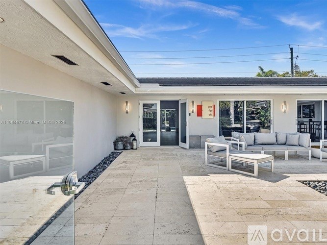 A modern house with a glass door and a white exterior.