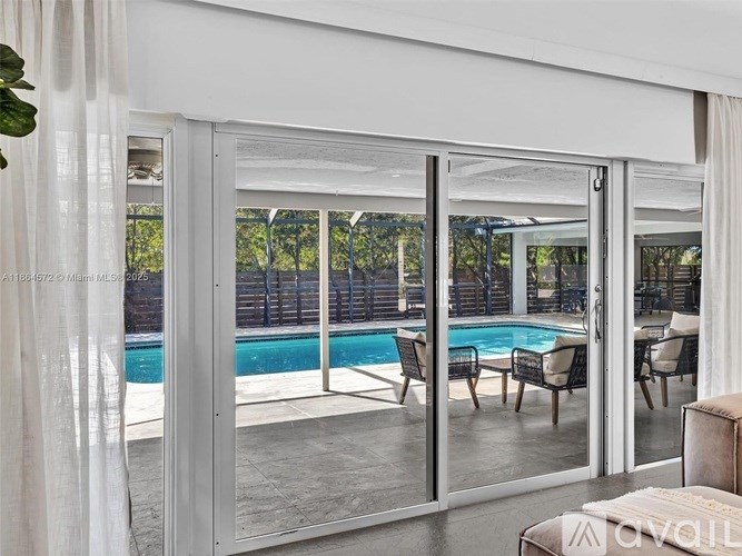 A modern house with a pool and glass doors.