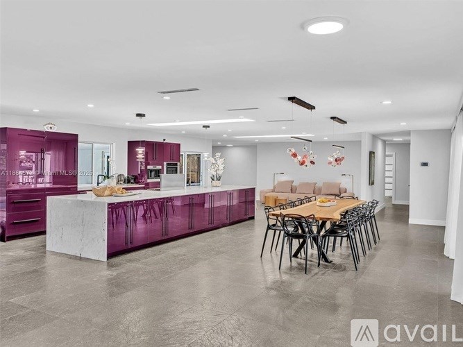A modern kitchen with a dining table set up.