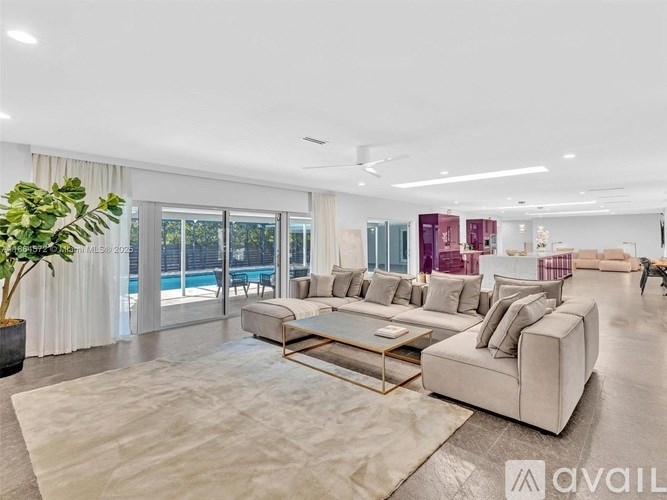 A spacious living room with a large sofa and a coffee table.