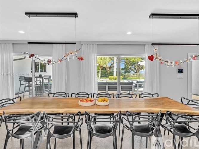 A dining room with a long table and chairs.
