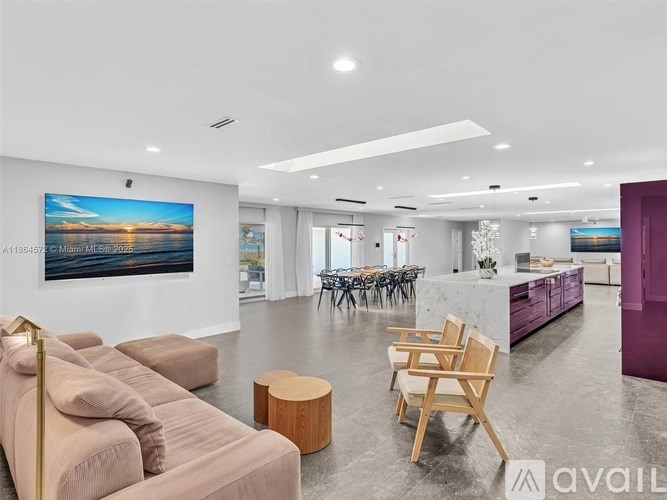 A living room with a large painting on the wall and a couch.