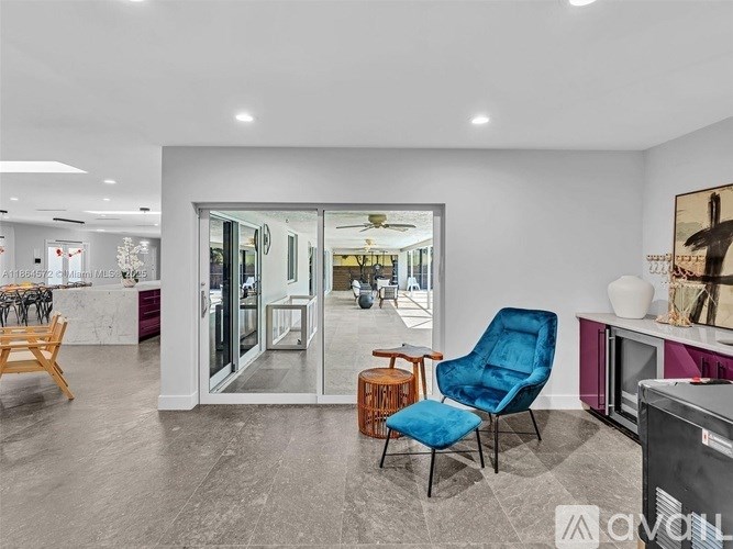 A living room with a blue chair and a television.