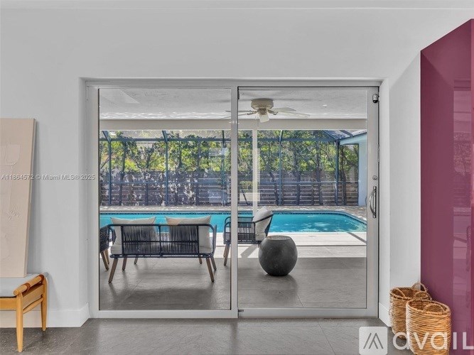 A modern room with a sliding glass door leading to a pool area.