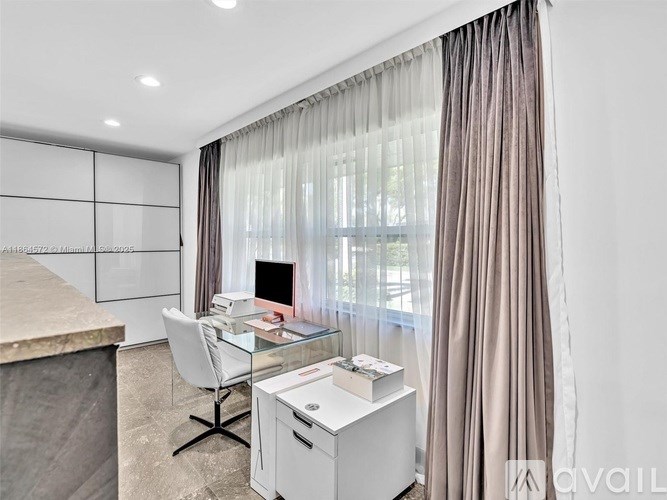 A modern home office with a desk, chair, and computer.