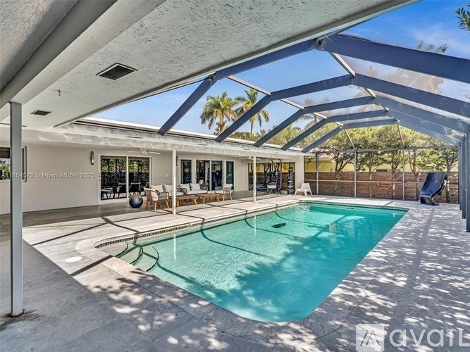 A swimming pool under a covered patio area.