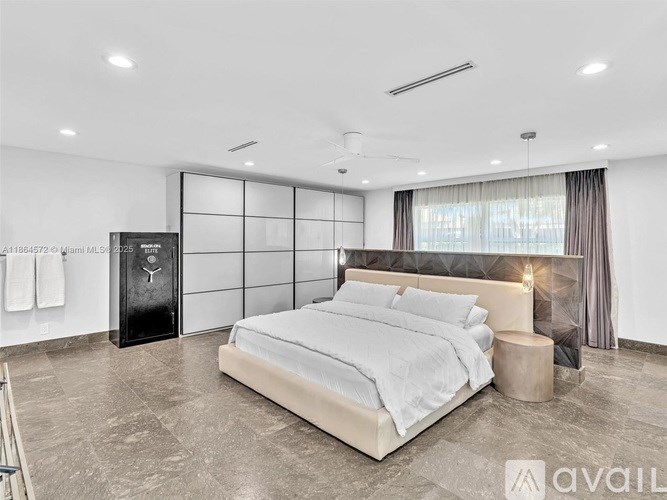 A modern bedroom with a large bed and a black cabinet.