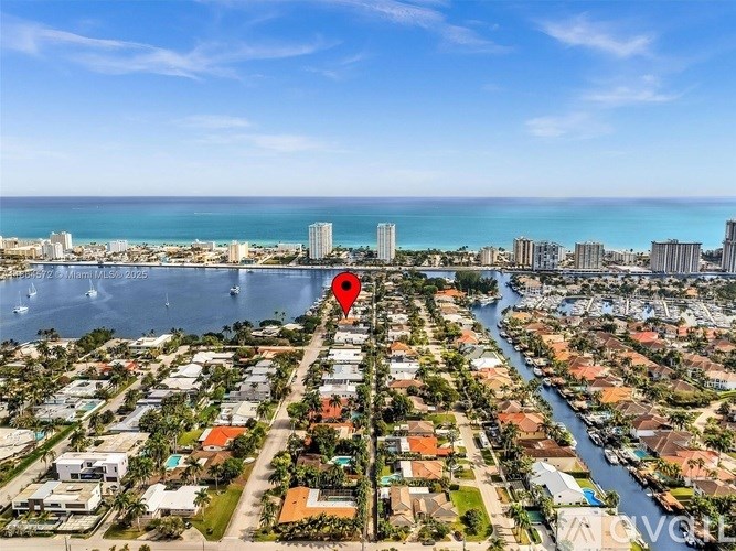 A red pin marks a location in a residential area with a river running through it.