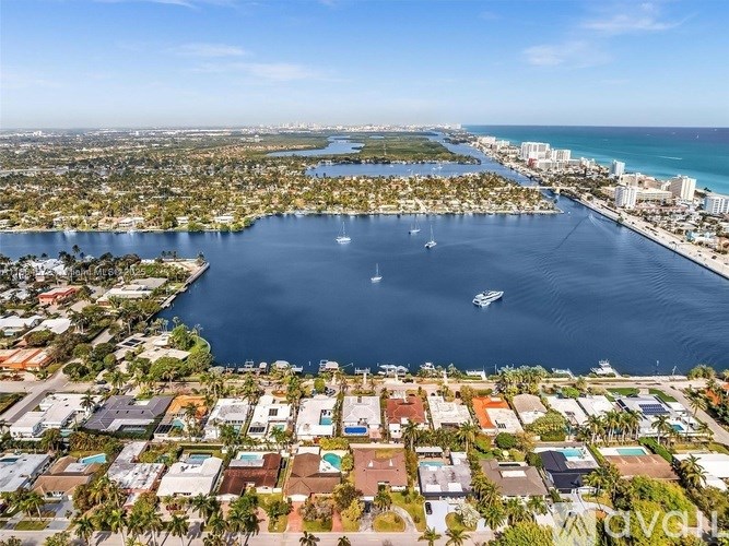 A large body of water surrounded by land with a boat in the water.