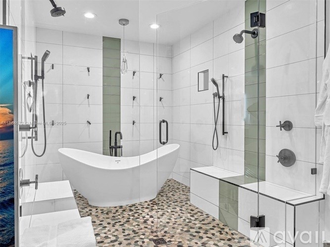 A modern bathroom with a white bathtub and a shower area.