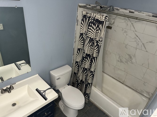A bathroom with a sink, toilet, and shower.