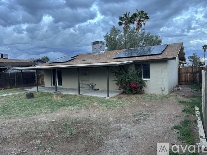 A house with a solar panel on the roof is for sale.