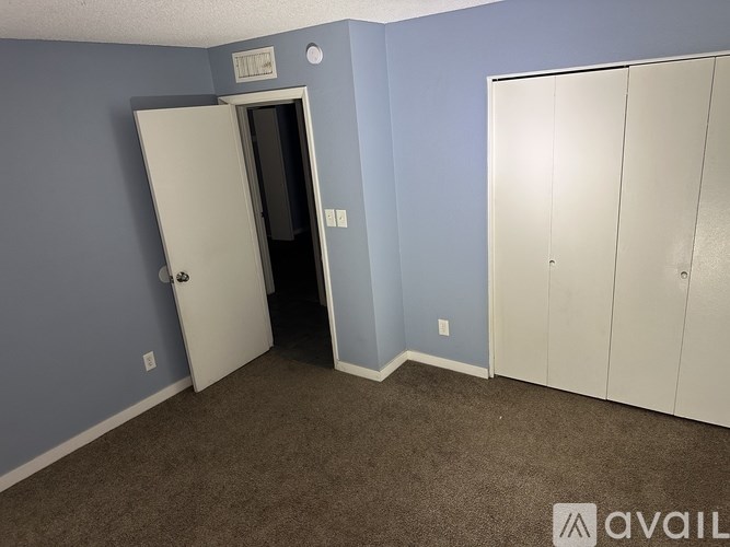 A room with a white door and a white wardrobe.