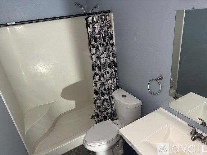 A white toilet sits next to a white sink in a bathroom.