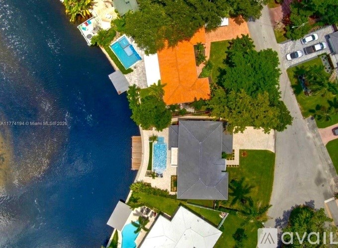 A bird's eye view of a property with a swimming pool and a large orange area.